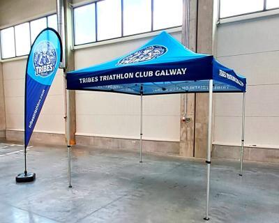 Blue-branded gazebo and flag for Tribes Triathlon Club, Galway, providing shelter and high brand visibility at events